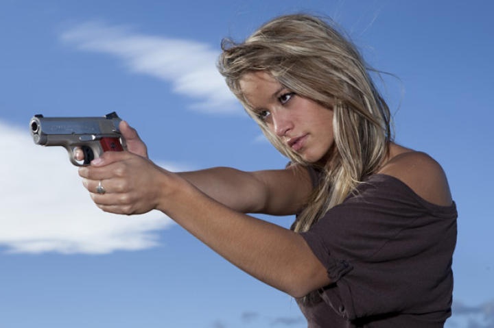 Paige takes aim with the Defender, a lighter, more compact model of the classic .45 that's her preferred personal sidearm.