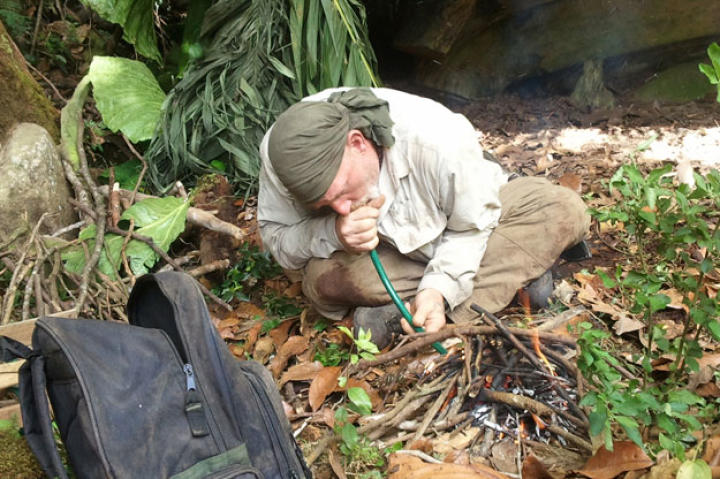 When the two-man deal finally descends below the saturated higher elevations, they are finally able to get a fire going. Dave uses a length of hose to create a bellows effect that cleverly speeds up the fire-starting process.