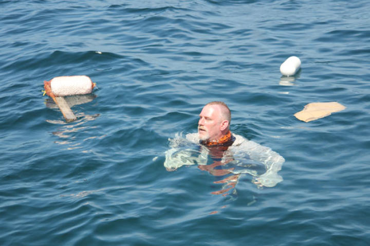 At the start of the shipwreck scenario Dave stays in the water to demonstrate the options for flotation devices and methods. With his extensive military training, Dave has the most experience in the challenges of water survival.