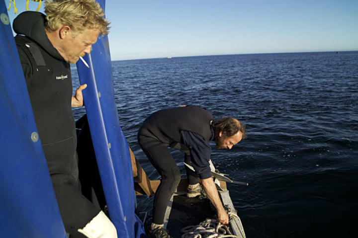 Boss Scott Meisterheim keeps a wary eye on Steve Riedel as he drops anchor.