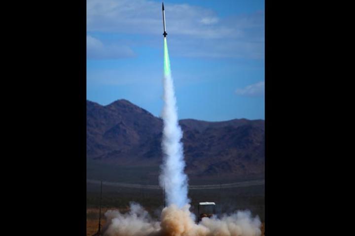 Here's a huge rocket moments after launch with a blue/green thrust fire.
