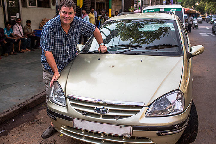 Mike Brewer posing with his second car purchase, a Tata Indigo Marina.
