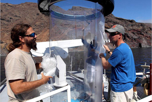 This contraption is called a "shark tube." Made of polycarbonate plastic, the shark tube is only a quarter of an inch thick, but strong enough to resist a great white — at least, shark expert Chris Fallows (right) hopes it is.