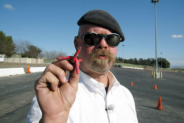 Jamie Hyneman shows off the tire spikes used to thwart a pursuing vehicle in Spy Car Escape.