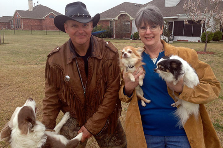 Ernie Brown, Jr., the Turtleman, and homeowner Linda Jangula pose with their beloved canine companions.