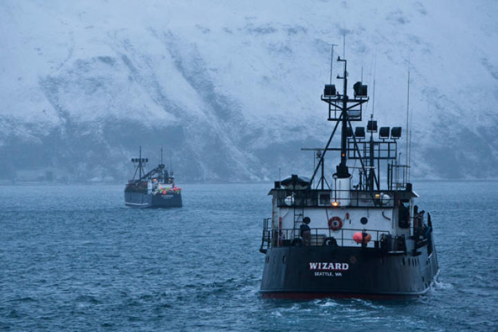 The Kodiak and Wizard head out to the open sea past the snow-covered mountains that ring Dutch Harbor.