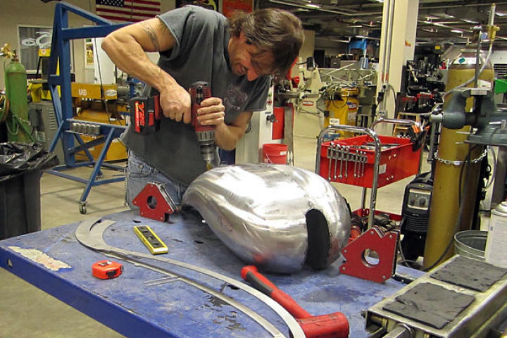 Rick Petko works on the gas tank for Orange County Choppers' Hard Rock Bike. There were some issues between the design on paper and the fabrication in reality, as revealed in the Chopper Aftershow.