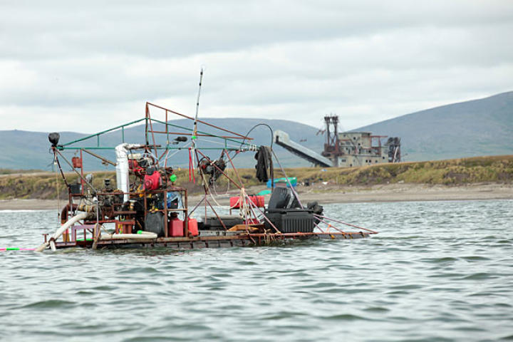 The 20-foot Clark is a junkyard beauty, rough looking but a solid build ideal for shallow water mining. Typical of her construction, the gold sluice is powered by an old VW engine.