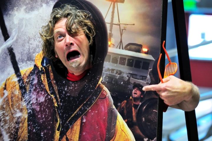 Wizard deckhand Travis Lofland hams it up in Gary Soper's "body" on one of the CatchCon face cutout boards. Just to be sure, he's also pointing to himself standing behind Gary on the deck when the photo was taken during last year's King crab season.