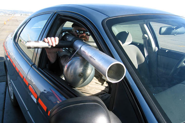 In order to test whether tossing a cup out a speeding car's window can injure or kill another driver, Jamie Hyneman built a shoulder-mounted soda-can cannon. Naturally.