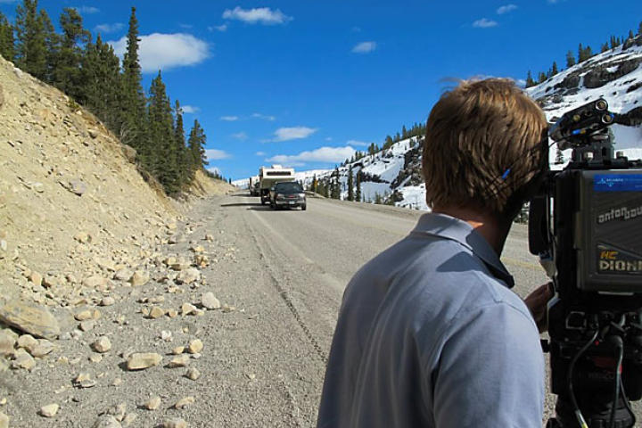 Jamie Berry, the producer-director for the first episodes of Gold Rush, films the miners' convoy along an Alaskan highway during the last leg of their journey to Porcupine Creek. Getting film crews in position at the right times along the route from Oregon to Alaska proved to be the first big challenge faced by the production team.
