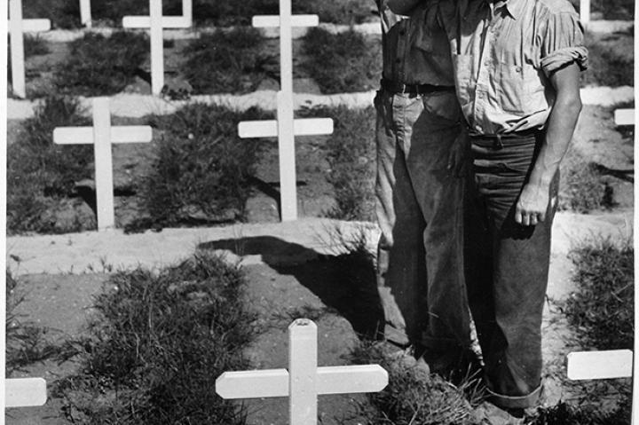 Coast Guardsmen pay silent homage to the memory of a fellow Coast Guardsman who lost his life in action in the Ryukyu Islands, a chain of Japanese islands that arc from Japan to Taiwan.