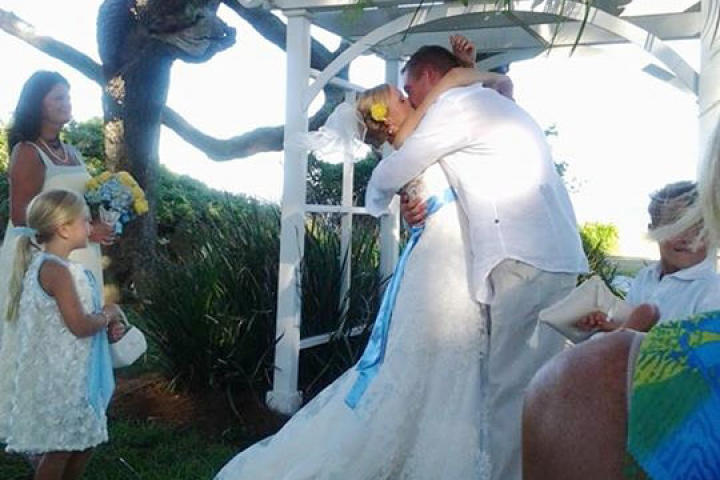 The couple shares their first kiss as husband and wife.
