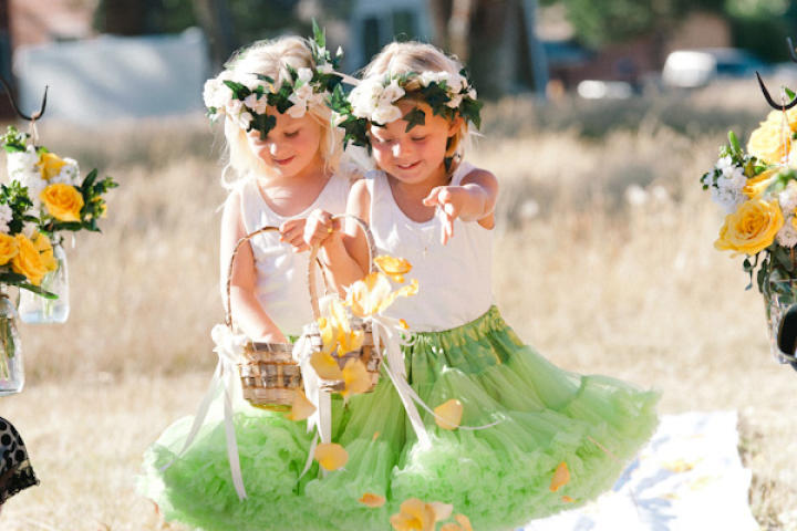 Flower girls wear green tutus and white cotton tanks.