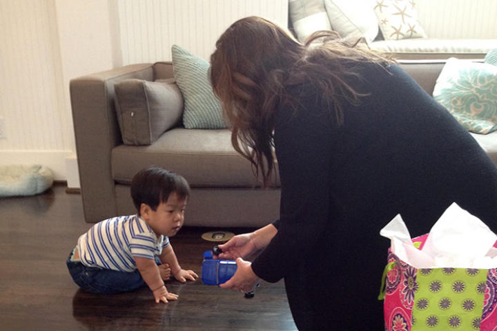 Will plays around with babysitter Kate while Bill, Jen and Zoey have their photo taken for