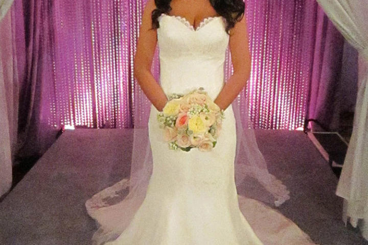 Technically speaking, fit and flare is a broad category of gowns that fit tightly through the bodice and flare into a skirt at some point below the hips. This dress, with a skirt that flares at mid-thigh, is a trumpet silhouette.