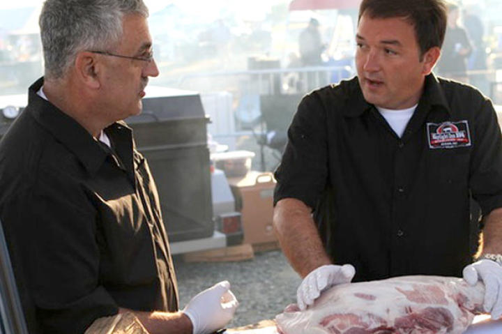 Sam Jones (right) of Skylight Inn BBQ Restaurant competes to see who is BBQ Pitmasters' North Carolina champion.