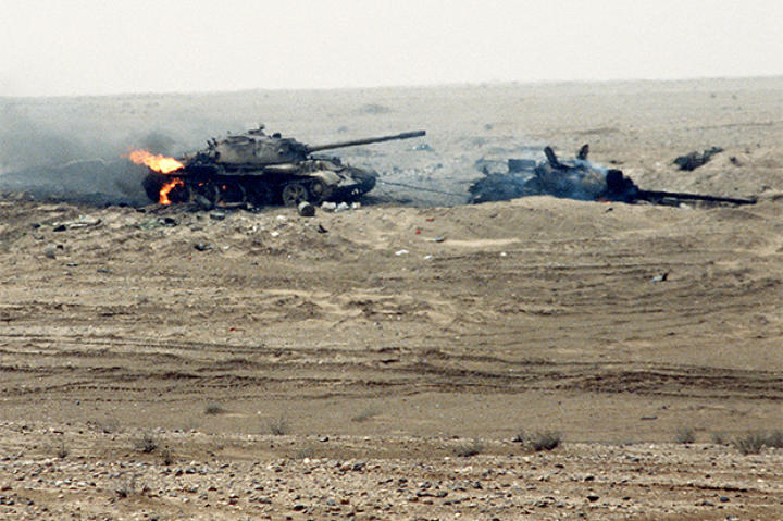 Still burning, these two Iraqi T-55 main battle tanks were damaged by a Coalition attack near the Kuwait border during Operation Desert Storm. The rear tank was attempting to tow the other one, as evidenced by the cable linking them, February 1991.
Watch