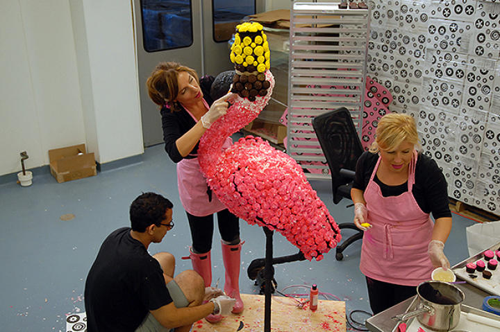 The HonFest flamingo is outfitted with pink coconut feathers and a bright yellow beehive.