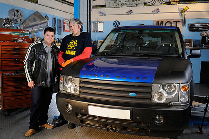 Mike and Edd pose leaning on RR in workshop.