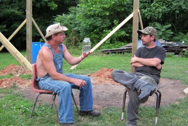 Tim shows off a jar of moonshiner to Tickle.