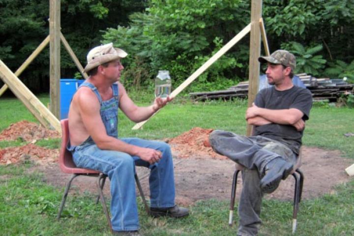 Tim shows off a jar of moonshiner to Tickle.