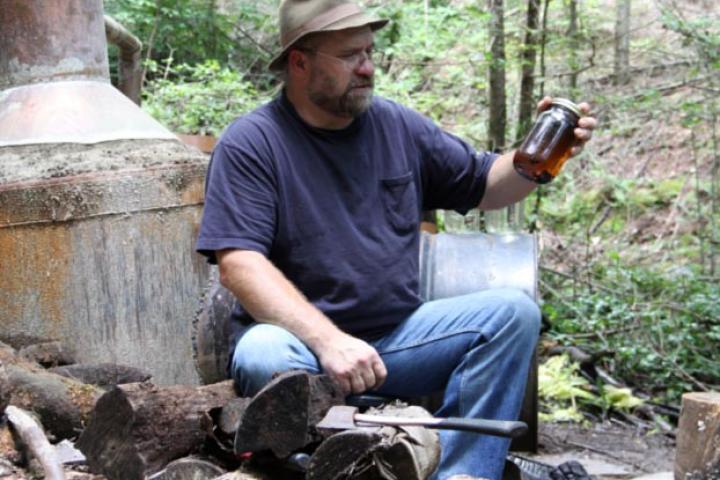 Jeff takes a moment to sit down next to his still.