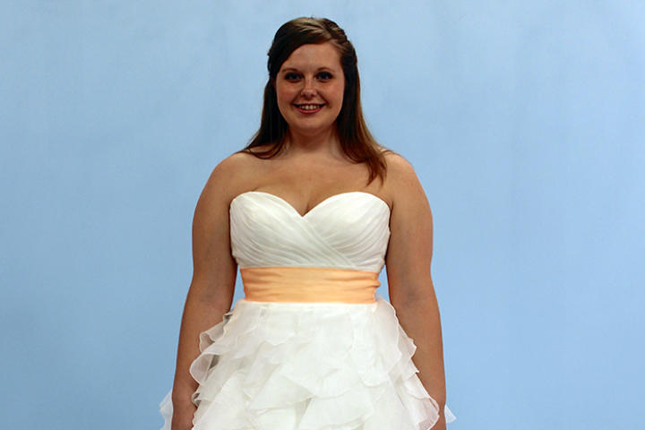 Audrey, a young bride from Indiana, had reservations about trying on bridal gowns -- she was worried her body wouldn't look good in them. So, she was pleasantly surprised when she saw her hourglass figure highlighted by fit and flare styles. Despite her family's opinion, Audrey chose this