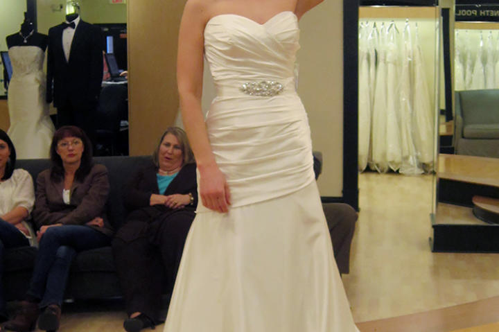 An ivory dropped waist A-line gown is retro screen siren with its sweetheart neckline and ample skirt.