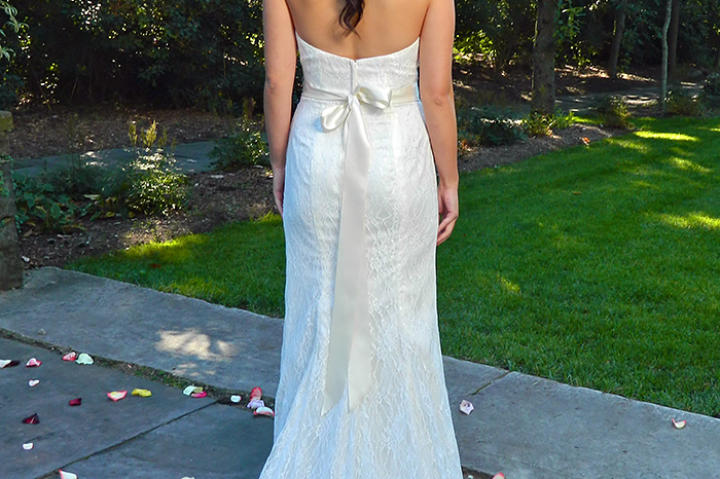 Jenny in her wedding dress from behind.