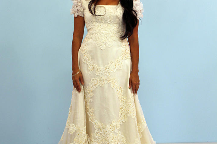 Karina called herself a daddy's girl, and that statement carried more meaning because her father had passed away. That's why it was so important that she wear her mother's dress -- it was one way of including him in the ceremony. This modest 1970s gown had an A-line silhouette, puffed sleeves and bow details. It was a well-fitting