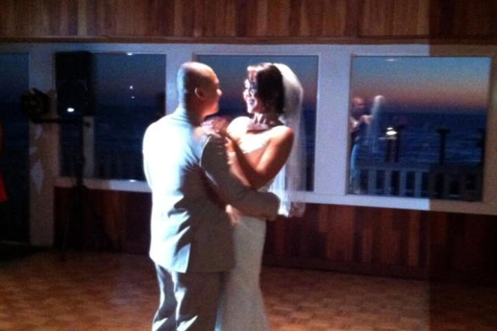 Karina dances with her groom in her Something New wedding dress.
