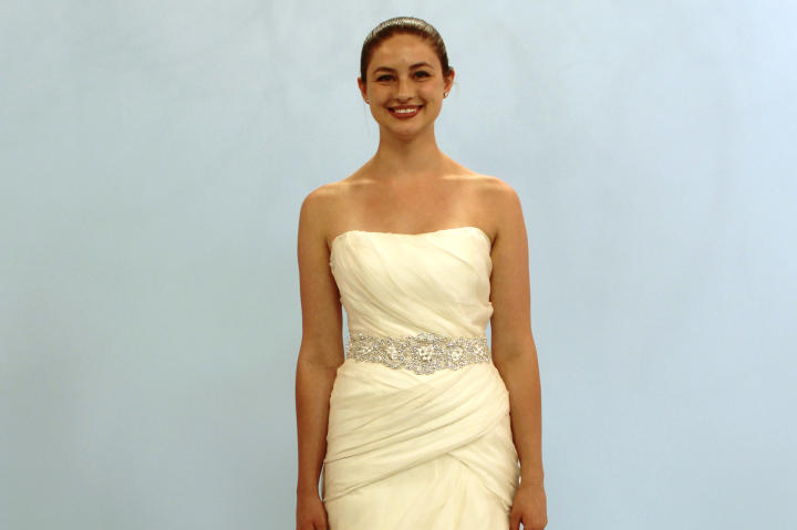 Kayla, a 23-year-old bride from Minnesota, was looking for a dress for her conservatory wedding. She imagined herself in something chiffon with crystal details. Though she chose her mother's dress after much deliberation, Kayla's