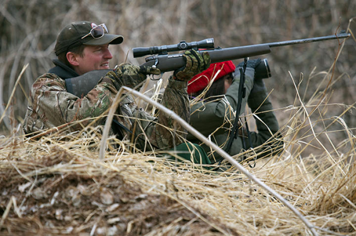 Atz Lee sets his aim at a possible target on the bluffs, while Jane helps get a closer look through binoculars.