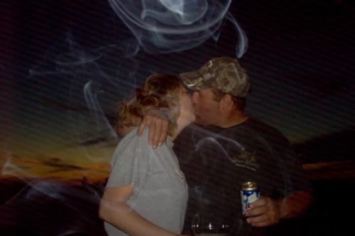 This is a fascinating picture that just happened to capture an angel. It was taken on Memorial Day weekend in 2008 of my husband and me. We were having a great time with our family at my parents’ that day and amazingly the energy of the evening just happened to get caught in a picture that my mom took of my husband and me being silly. I'm reluctant to show it to many people because I'm not crazy about being seen in such an intimate manner, but feel it deserves being shared because of the rarity of capturing something like this on camera. It's nice knowing that our angels enjoy being a part of our celebrations too!
--Kimberly M.
