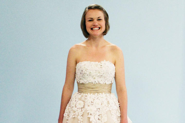 Midwestern bride Sally had to have a tea-length wedding dress so she could square dance at her reception. She loved this unique coffee and cream-colored tulle gown with Venice lace and elegant beading. By Justin Alexander, the