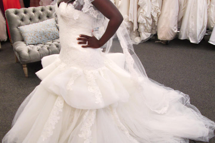Ft. Lauderdale-based fashion stylist Tohni wanted two dresses: "something over the top" for the ceremony, and "something amazing" for the reception. "I'm not being a diva," she said, "but I know what I want." For her ceremony dress, she chose this Manuel Mota gown, originally priced at $3,900 and available at Vows for $1,950. See her reception dress next.