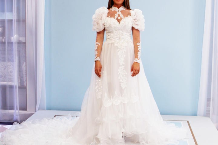 Alysha and Jen both considered wearing their mother's 1980s ruffled satin gown with puff sleeves and beaded appliques. While Jen felt a sentimental attachment to the bright white gown, Alysha (pictured) thought it should be hers to wear as the oldest daughter.