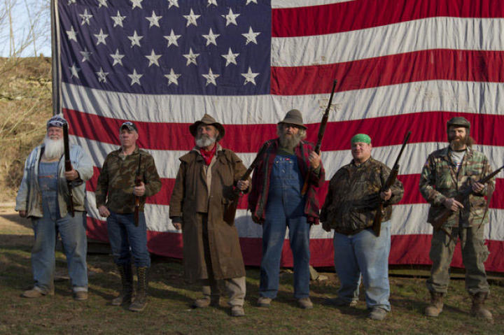 Team AIMS (Appalachian Investigators of Mysterious Sightings) poses in front of an American flag.
