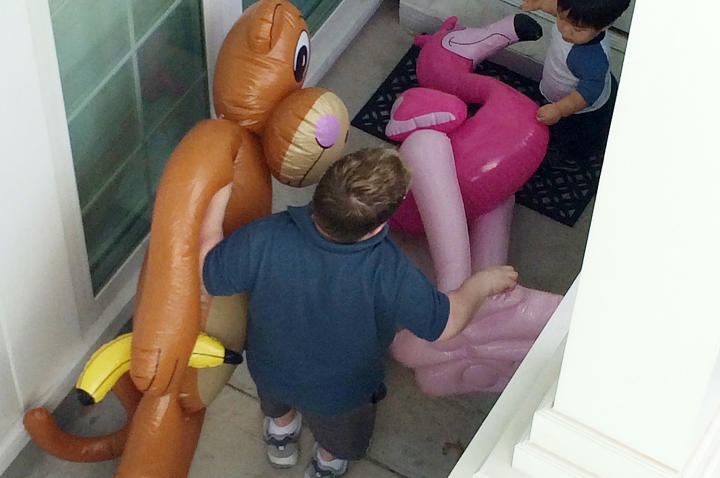 Bill and Will take some of the decorations for the birthday party to the car before going to the zoo.