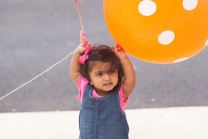 Zoey is one happy birthday girl with her country glam ensemble and a balloon in each hand.