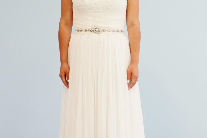 Kelly's alterations cost just $1,050 and included a new layer of French lace and restructured cap sleeves. Sheena agreed this elegant, flowing chiffon A-line was much improved, but she preferred her new dress.