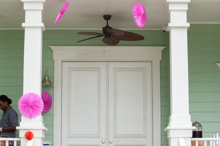 Will and Zoey anticipate guests' arrival for Zoey's farm chic-themed birthday party! A playful sign above the porch reads "Zoey's Farm." Jen chose the theme because Zoey loves the song "Old MacDonald Had a Farm."
