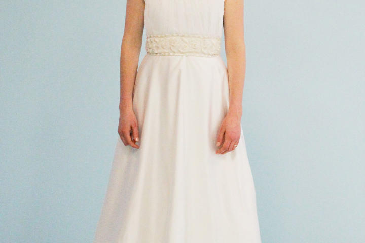 It cost Kelly $1,070 to make over Sally's borrowed gown into this A-line dress with lace straps and antique ivory accent belt. Cotton mesh netting on the neck and skirt nod to the informal Midwestern theme. Sally said she'd be wearing this dress on her wedding day!