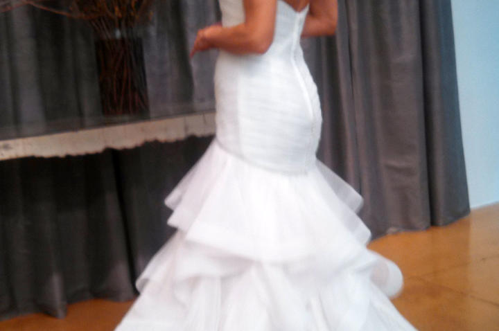 "Brides will always want this kind of shape and this dramatic skirt," Monte says, "but Judd Waddell has really improved the design." Note the seam between bodice and skirt. It's angled to cup the butt, offering heightened sex appeal and creating greater ease of movement.