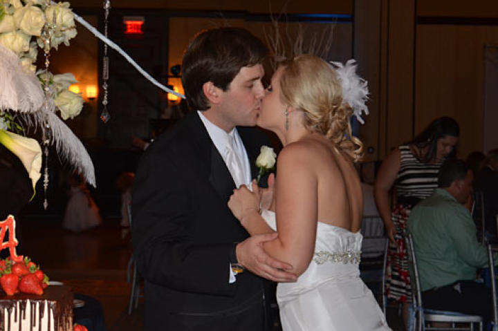 Holly and Robert exchange a kiss at the wedding.