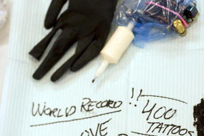 Creating tattoos is a skilled art. The basic supplies include gloves, disinfectant, ink, and tattoo needle, which attaches to a foot-pedaled machine that pumps the ink through the needle into the skin.