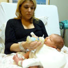 Mommy time! Lisa gives baby Carlo one of his first bottles.