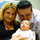 Mommy and Daddy shower their new bundle with plenty of love.