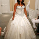 A dramatic satin ball gown has a crystal-encrusted bodice.